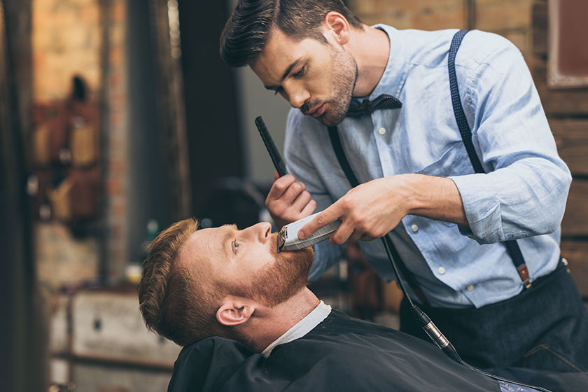 barber-trimming-customers-beard